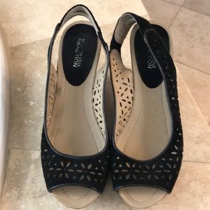 Black suede clogs with flower laser cuts.